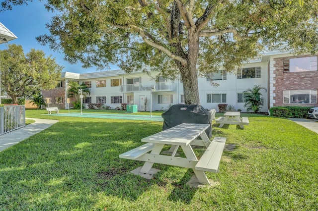 view of property's community with a lawn