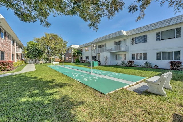 surrounding community featuring shuffleboard and a lawn