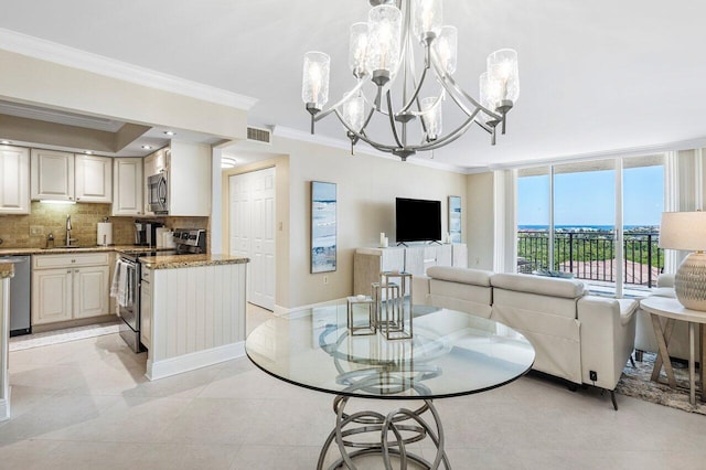 dining room with visible vents, crown molding, baseboards, an inviting chandelier, and light tile patterned flooring