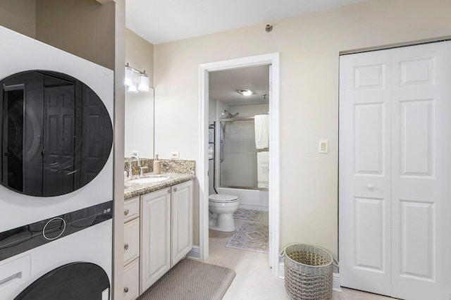 full bathroom featuring toilet, vanity, and shower / bath combination with glass door