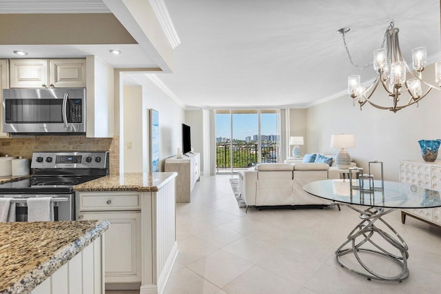 kitchen featuring ornamental molding, light stone counters, backsplash, appliances with stainless steel finishes, and light tile patterned floors