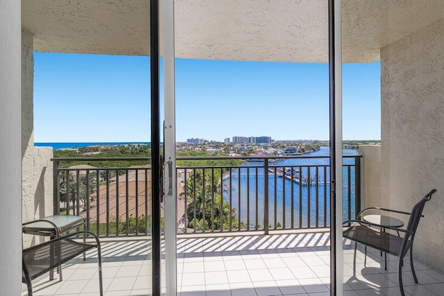 balcony featuring a view of city and a water view