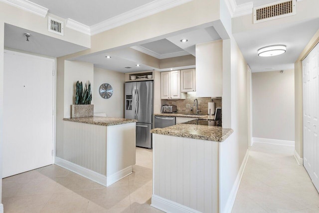 kitchen featuring visible vents, appliances with stainless steel finishes, crown molding, and a peninsula