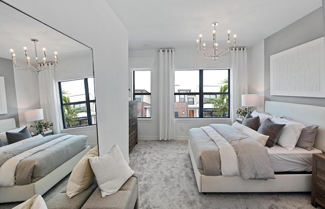 bedroom featuring light colored carpet, baseboards, and a notable chandelier