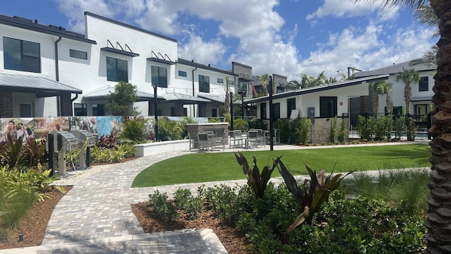 surrounding community with a residential view, a yard, and fence