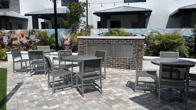 view of patio featuring outdoor dining space and fence