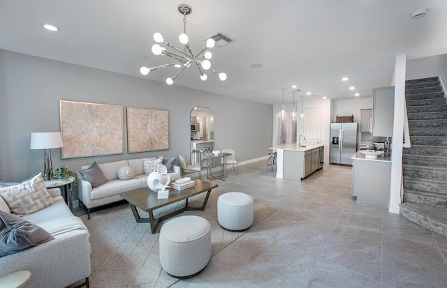 living room featuring visible vents, an inviting chandelier, recessed lighting, arched walkways, and stairs