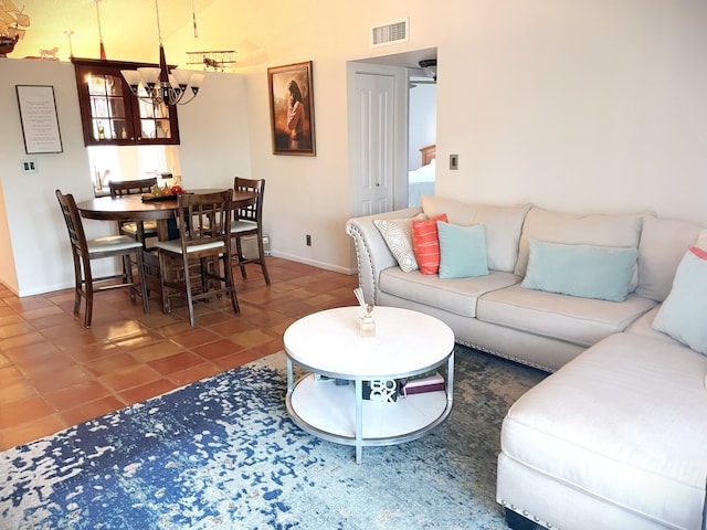 tiled living area with a notable chandelier, baseboards, and visible vents