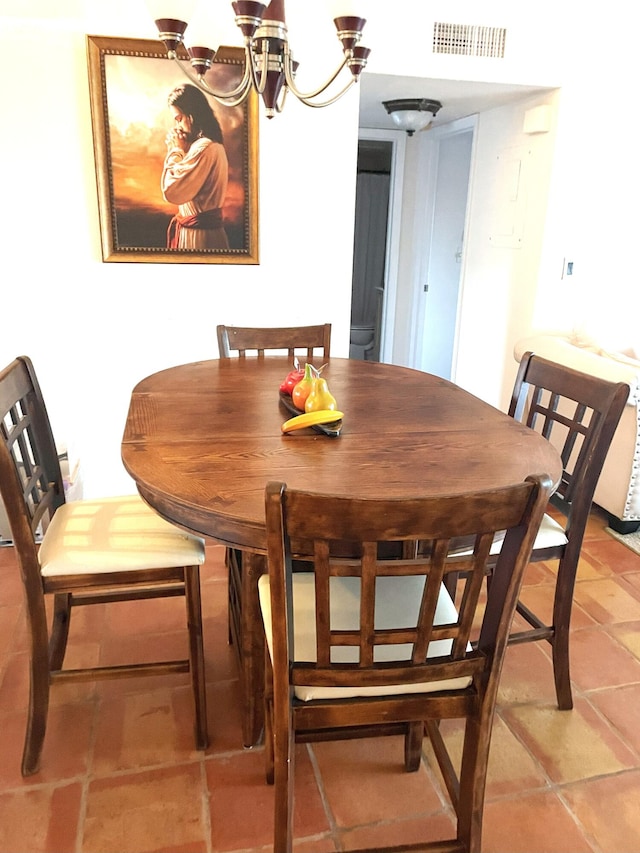 dining space with light tile patterned floors, visible vents, and an inviting chandelier