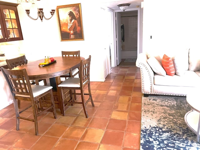 dining room featuring an inviting chandelier and light tile patterned floors