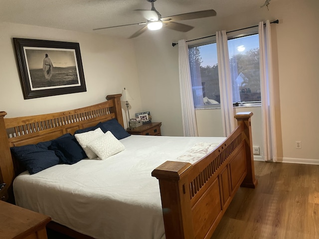 bedroom featuring baseboards, ceiling fan, and wood finished floors