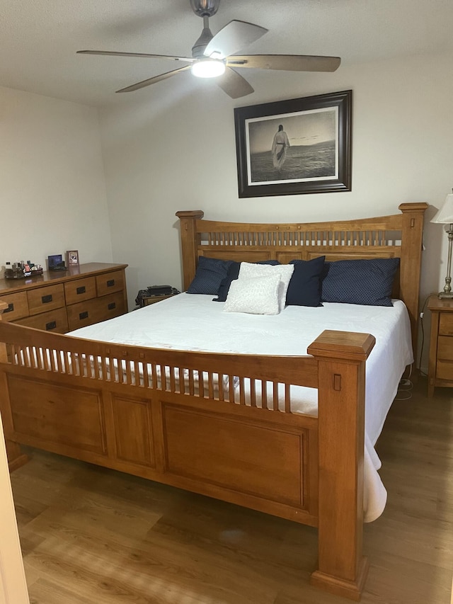 bedroom featuring ceiling fan and wood finished floors