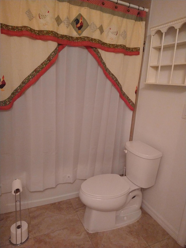 full bathroom featuring tile patterned flooring, toilet, and baseboards