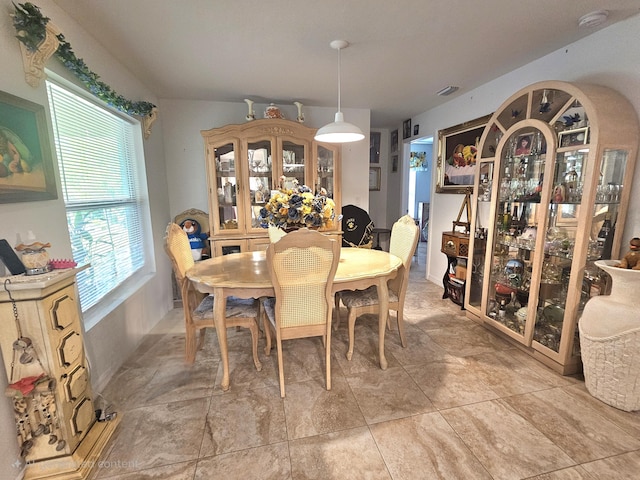 dining space featuring arched walkways and visible vents