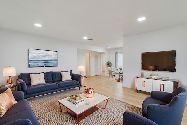 living area with visible vents, recessed lighting, and light wood-type flooring