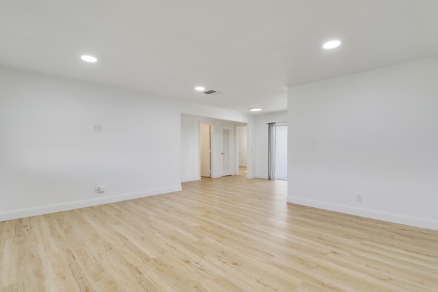 spare room with light wood-style floors, recessed lighting, and baseboards