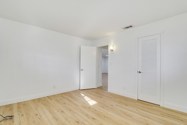 unfurnished bedroom with visible vents, baseboards, and light wood-style flooring