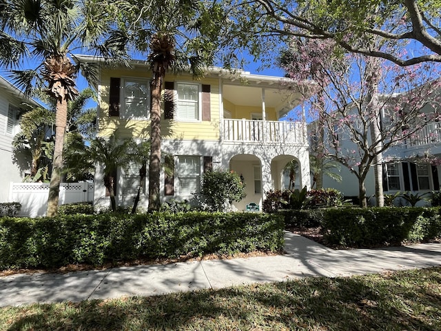 view of front facade with a balcony and fence