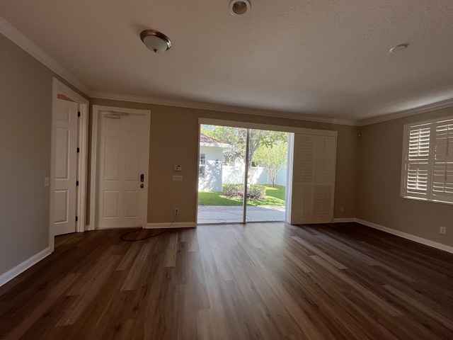 unfurnished room with baseboards, dark wood-type flooring, and crown molding