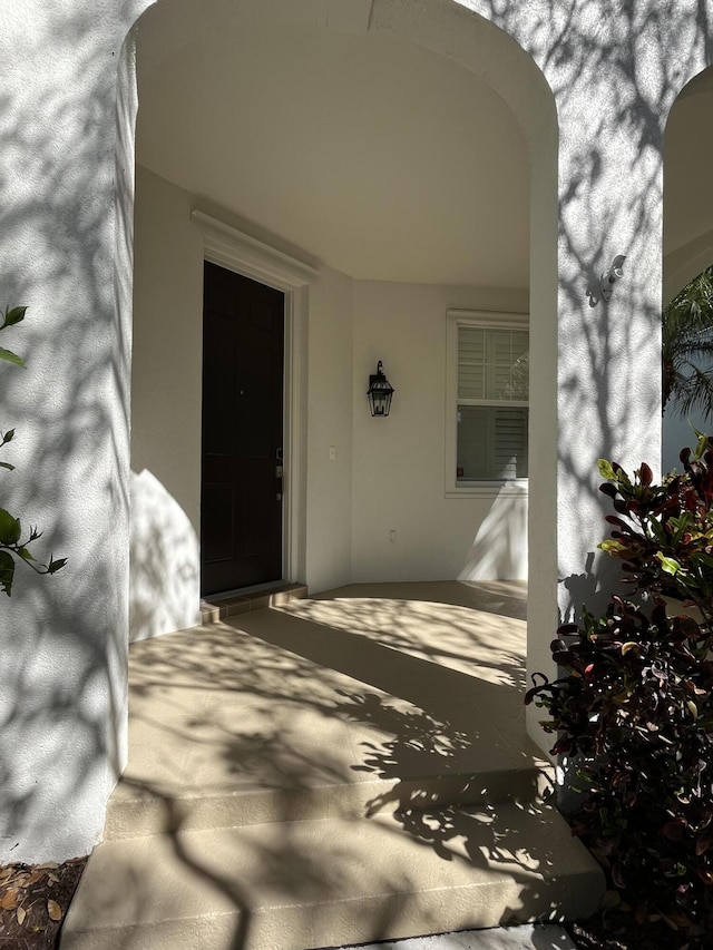 entrance to property featuring stucco siding