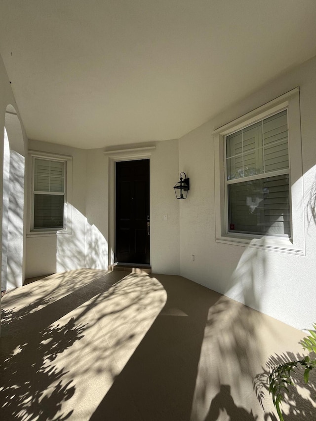 doorway to property with stucco siding and a patio