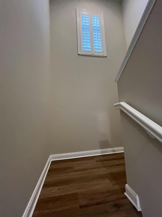 staircase featuring visible vents, baseboards, and wood finished floors