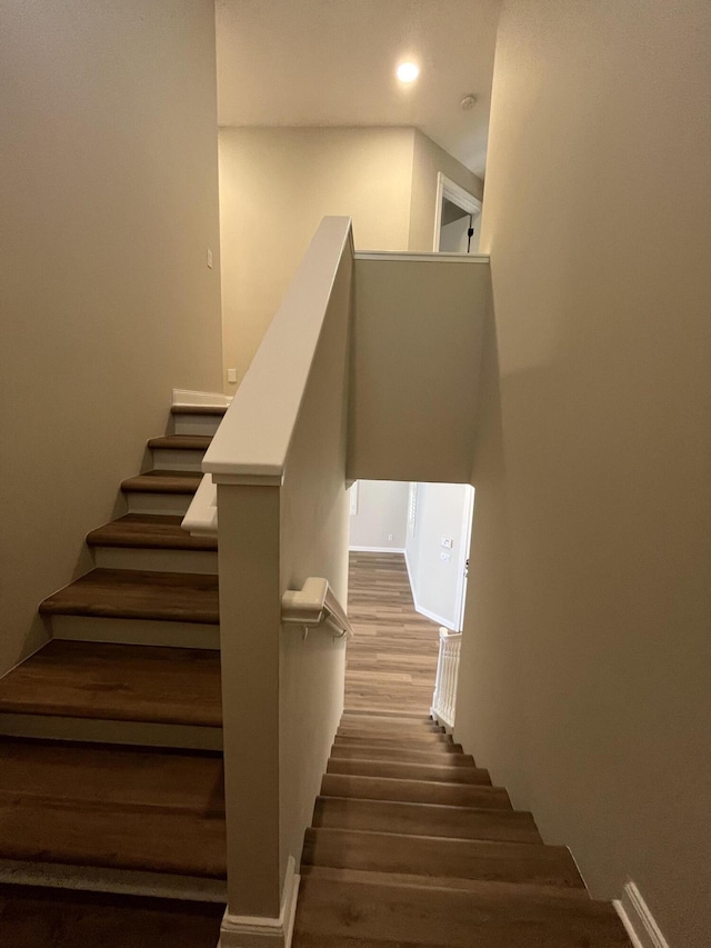 staircase featuring recessed lighting and wood finished floors