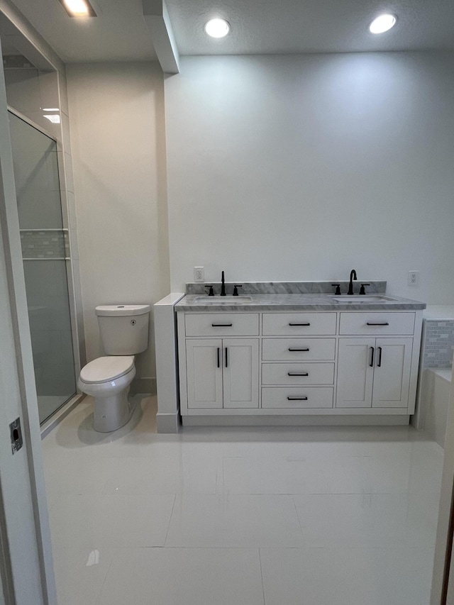 bathroom with a shower stall, toilet, recessed lighting, and a sink