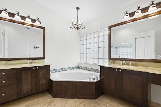 full bathroom featuring a garden tub, two vanities, and a sink