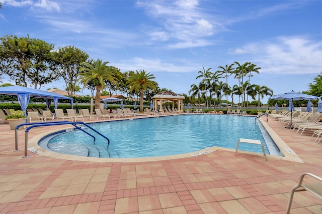 community pool featuring a gazebo, a patio, and fence