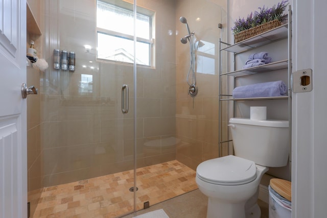 bathroom featuring a stall shower and toilet