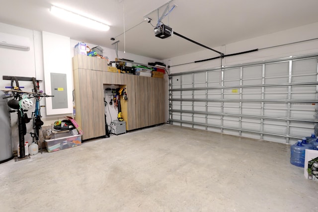 garage with electric panel, a garage door opener, and a wall mounted AC