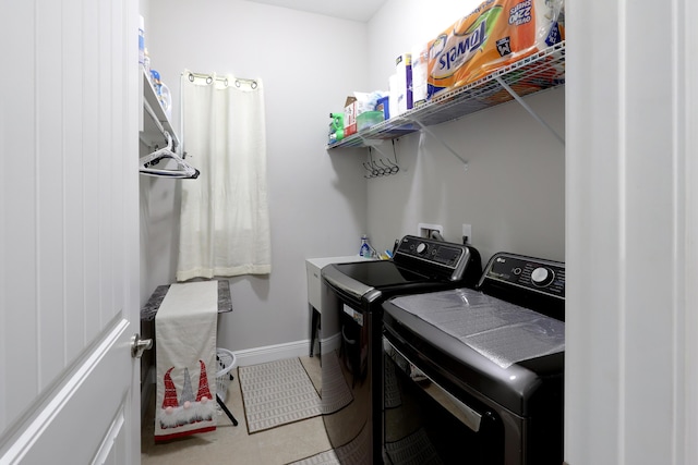 laundry room featuring tile patterned flooring, laundry area, independent washer and dryer, and baseboards