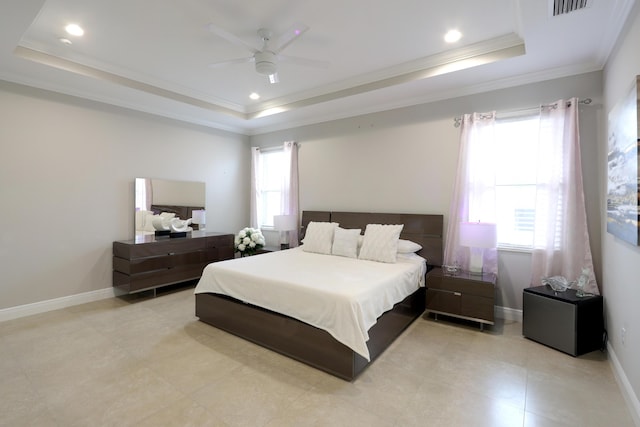 bedroom featuring a tray ceiling, multiple windows, and ornamental molding