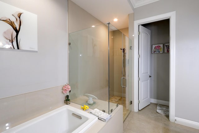 full bath with recessed lighting, a bath, baseboards, and a stall shower