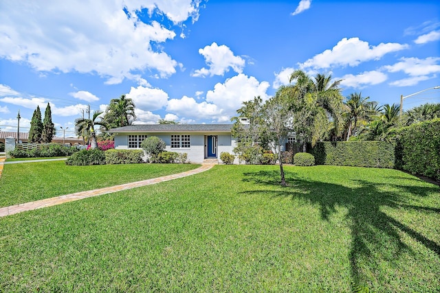 single story home with a front yard and fence