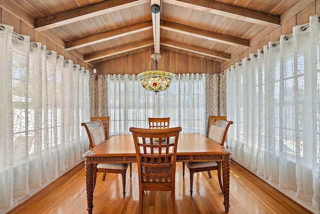 dining area with a healthy amount of sunlight, wooden ceiling, vaulted ceiling with beams, and light wood-style floors