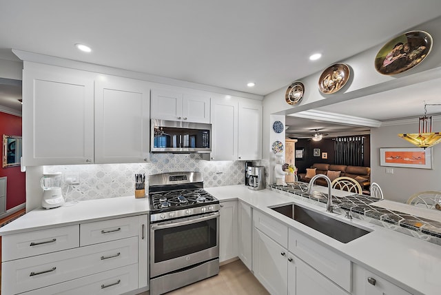 kitchen featuring a sink, light countertops, tasteful backsplash, and stainless steel appliances