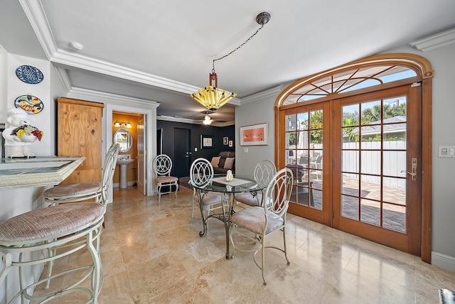 dining room with crown molding, french doors, and baseboards