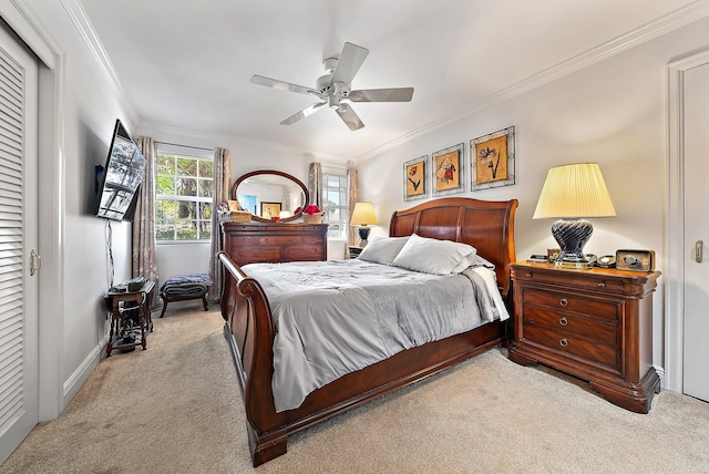 bedroom with baseboards, a ceiling fan, carpet flooring, and crown molding