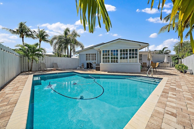 view of pool featuring a fenced in pool, a fenced backyard, and a patio area