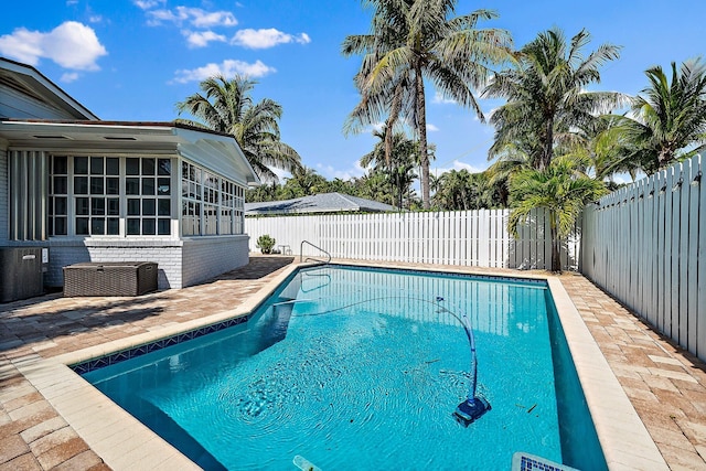 view of swimming pool with a patio area, a fenced in pool, and a fenced backyard