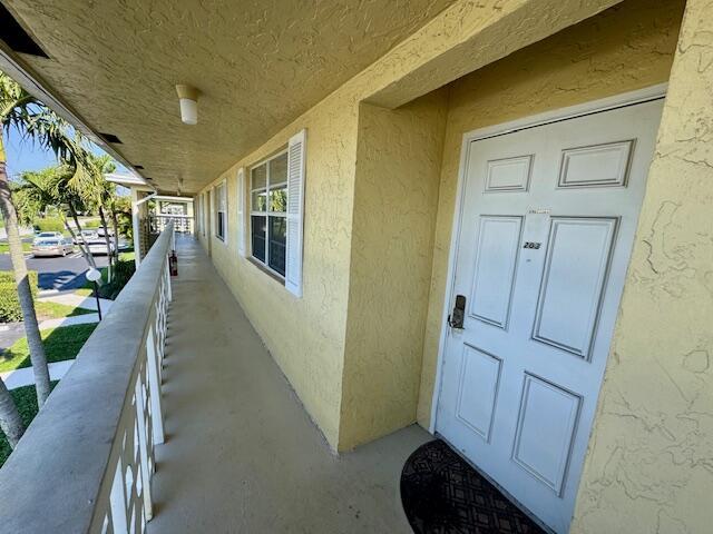 doorway to property with stucco siding