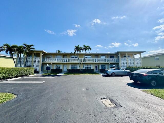 view of building exterior featuring uncovered parking