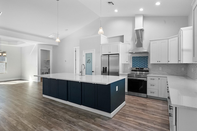 kitchen with visible vents, wall chimney range hood, dark wood-style floors, appliances with stainless steel finishes, and light countertops