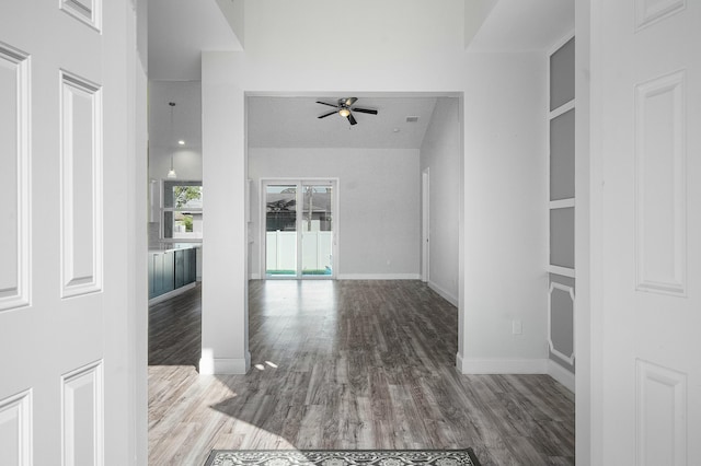 interior space featuring visible vents, ceiling fan, baseboards, and wood finished floors