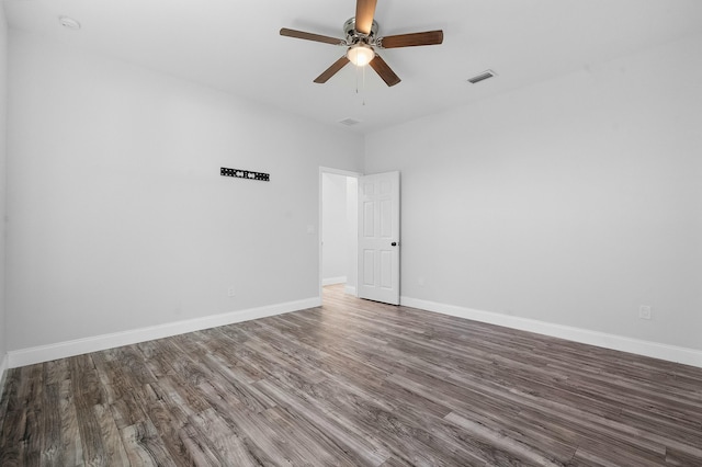 spare room with visible vents, ceiling fan, baseboards, and wood finished floors