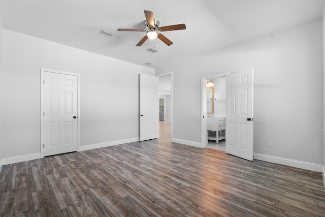 unfurnished bedroom with dark wood-style floors, visible vents, and baseboards