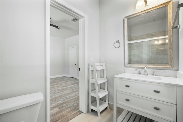 full bathroom with vanity, wood finished floors, visible vents, a shower stall, and toilet