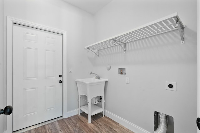 laundry area featuring electric dryer hookup, wood finished floors, baseboards, hookup for a washing machine, and laundry area